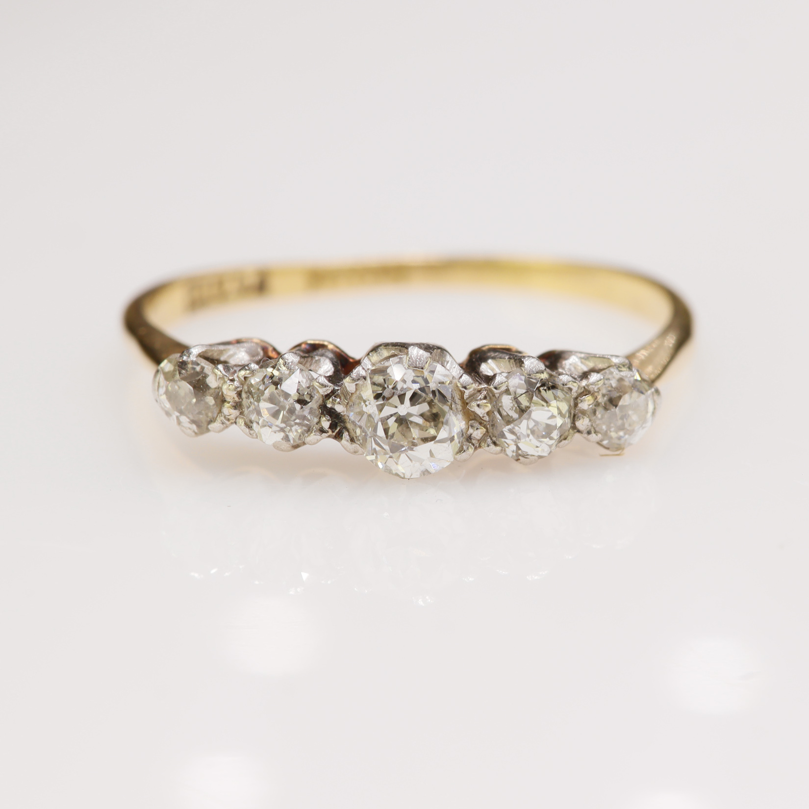 Yellow gold (tests 18ct) diamond five stone ring, set with graduating old cuts, principle approx 0.