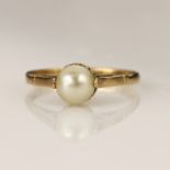 Yellow gold (tests 9ct) pearl solitaire ring, cultured pearl measures 6mm, flanked with one claw