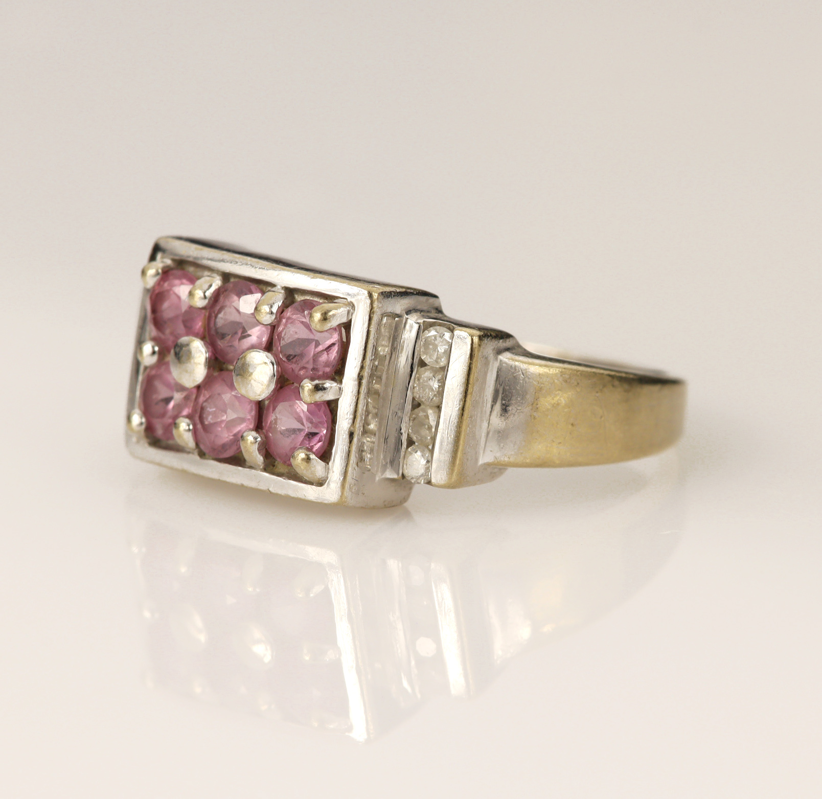 18ct white gold pink sapphire and diamond dress ring, set with six round mixed cut Sri Lankan 'hot