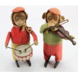 Schuco. Two Schuco tinplate clockwork monkeys, one playing the drums, the other playing the