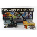 Atari CX 2600 boxed console, with a group of games (sold as seen)