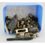 Thimbles. A collection of various thimbles, together with a silver hallmarked matchbox holder (107