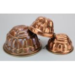 Jelly Moulds. Three 19th Century copper jelly moulds, largest height 12cm, diameter 22.5cm approx.