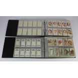Modern albums (2) of cigarette card sets in sleeves, one album military related including Victoria