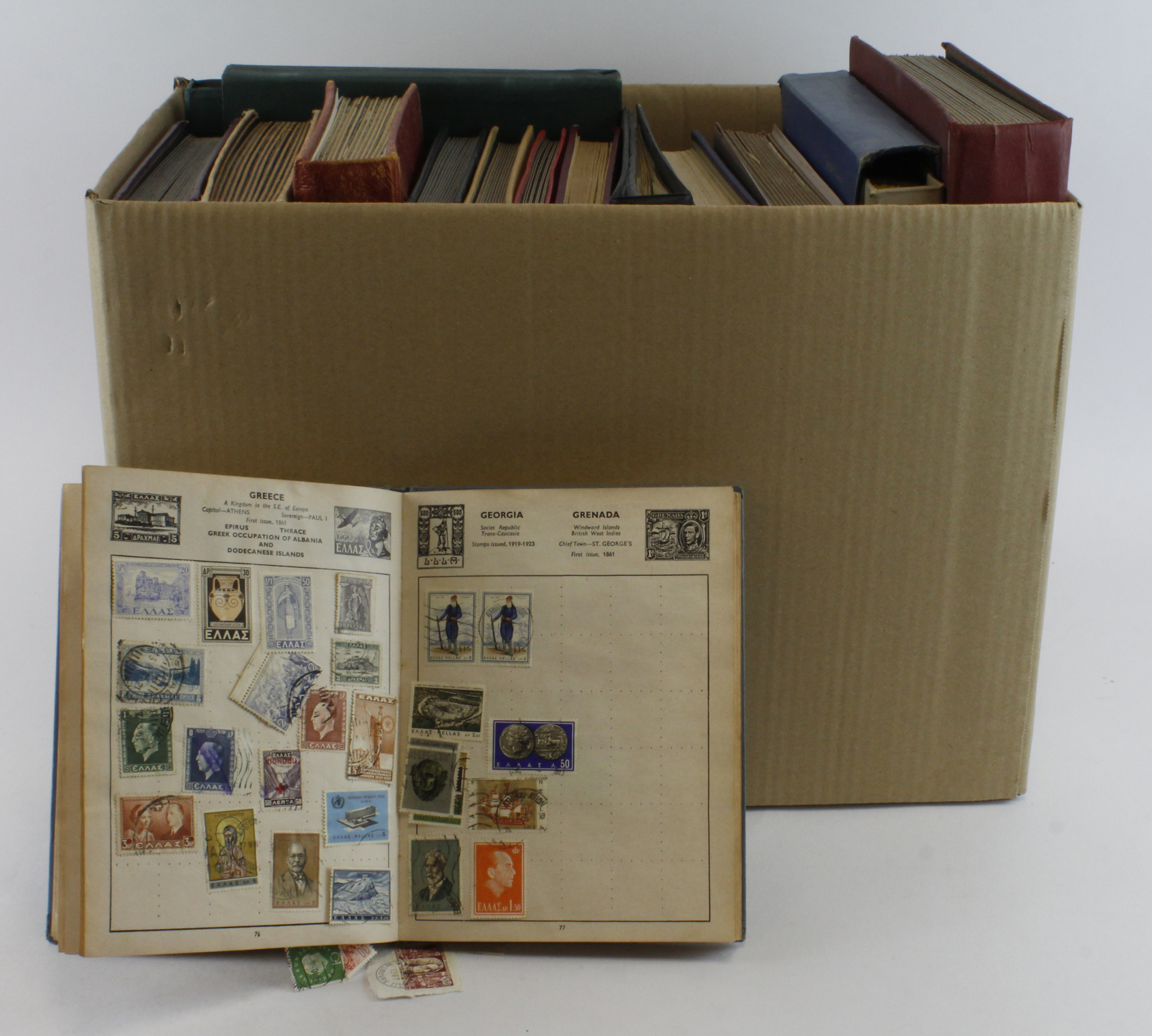 Large and very heavy box of World material in various albums / stockbooks, and two one country