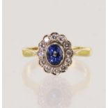 18ct yellow gold diamond and sapphire cluster ring, ovall sapphire measures 5mm x 4mm, surrounded by