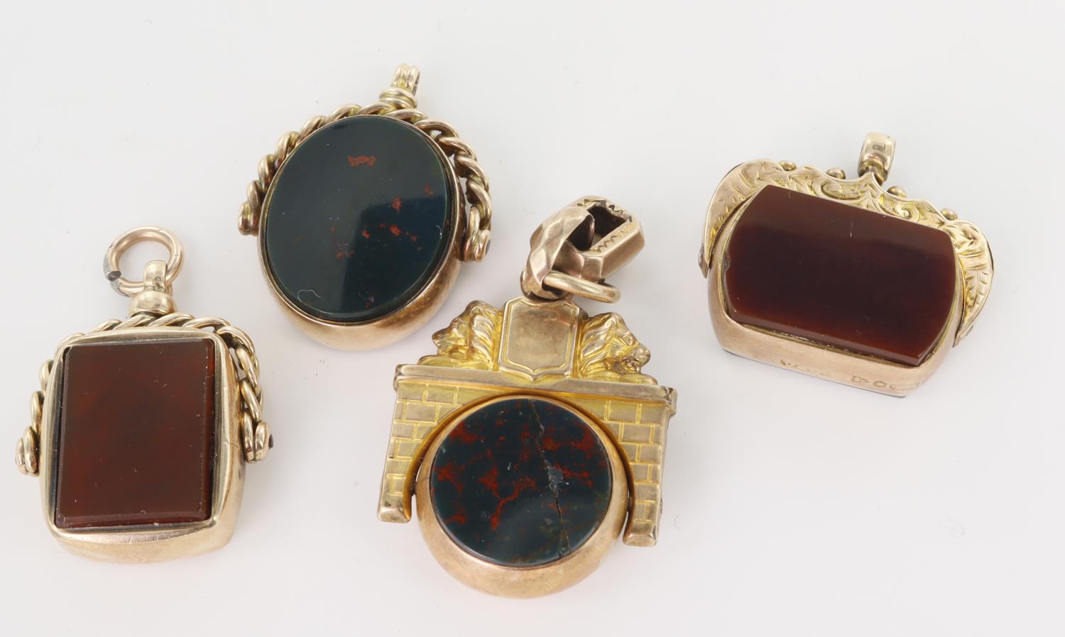 Four 9ct yellow gold Victorian and Edwardian swivel fob pendants, set with bloodstone and cornelian,