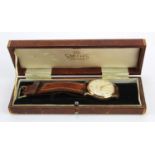 Gents 9ct cased Smiths "Deluxe" wristwatch. The cream dial with arabic numerals and subsidiary