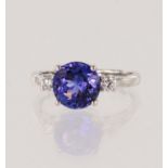 18ct white gold diamond and tanzanite trilogy ring, round tanzanite grade AAA measures 8.9mm,