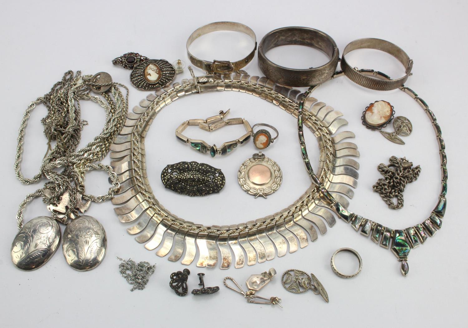 Assortment of silver/white metal jewellery, items include brooches, necklaces, vintage bangles,