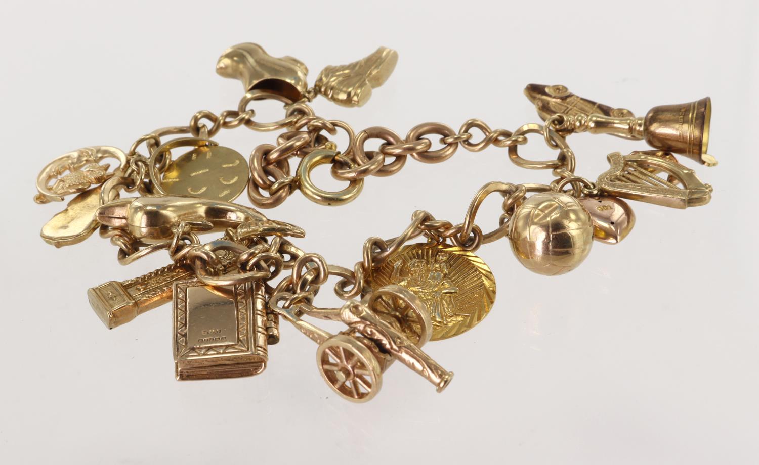 9ct / Yellow metal charm bracelet with a good variety of charms attached. Total weight 32.9g