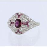 White metal tests platinum ruby and diamond art deco style cluster ring, principle oval mix cut ruby