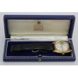 Gents 9ct cased Garrard automatic wristwatch. The silver dial with gilt baton markers. Case width