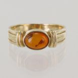 9ct yellow gold ring with oval amber cabochon measuring approx. 8mm x 6mm, finger size N, weight 3.