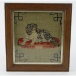 Spaniel interest. Embroidered needlework depicting a Spaniel on a cushion, framed and glazed,