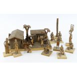 Figures. An unusual group of African wooden carved figures and buildings, tallest 12cm approx. (sold