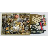 Gold coloured tin of mixed militaria including medals, cap badges, buttons, etc. (Qty)