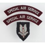 Cloth badges: S.A.S. Beret badge and Special Air Service pair of shoulder title badges worn by