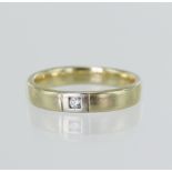 Yellow gold (tests 14ct) diamond ring, one round brilliant approx. 0.03ct, 3mm wide court profile,