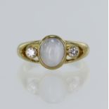 Yellow gold (tests 18ct) star sapphire and CZ ring, oval cabochon star sapphire approx. 4.67ct,
