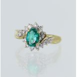 Yellow gold (tests 18ct) diamond and synthetic emerald cluster ring, syn. emerald measures 7mm x