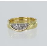 18ct yellow gold diamond set ring, nine round brilliant cuts set in a white gold pave setting, TDW