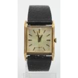 Gents 9ct cased Garrards manual wind wristwatch. The square silver dial with gilt baton markers