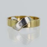 Yellow gold (tests 18ct) contemporary diamond ring, white ribbon detail set with one round brilliant