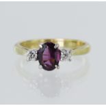 18ct yellow gold diamond and rhodolite garnet trilogy ring, oval rhodolite measures 6.6mm x 5mm,