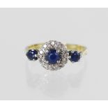 Yellow gold (tests 18ct) sapphire and diamond ring, principal sapphire measures 4mm surrounded by