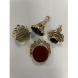 Four 9ct yellow gold fob pendants, stones include citrine, cornelian, bloodstone and onyx, total