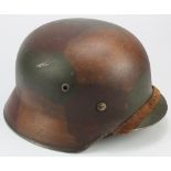 German M35 combat helmet with old liner and chin strap, maker marked ET. Normandy type camo.
