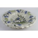 Delft 17th Century dish, depicting a figure on horseback to centre, surrounded by floral decoration,