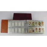 Modern albums (2) full of cigarette card sets, one album full of sport related sets from Players,