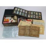 Banana box of loose & some stuck in cigarette cards and trade cards, in sleeves, loose in old