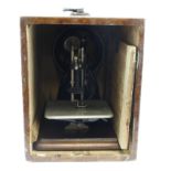 Wilcox & Gibbs sewing machine, height 25.5cm, length 32cm approx., contained in original wooden case