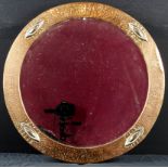 Arts and crafts round bevel edged mirror with a hammered copper surround and embossed with a