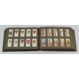 Large vintage album full of loose cigarette card sets (x22) including Britains Defenders, Military