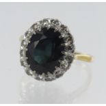 Yellow gold (tests 18ct) diamond and sapphire cluster green, greenish blue sapphire measures 12mm