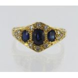 18ct yellow gold diamond and sapphire dress ring, three graduating oval sapphires, principle