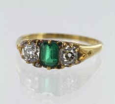 Yellow gold (tests 18ct) vintage emerald and diamond trilogy ring, one step cut emerald measuring