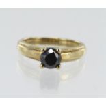 9ct yellow gold black synthetic diamond solitaire, one 6mm round brilliant cut, four claw set,