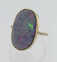 Yellow gold (tests 9ct) opal doublet dress ring, oval doublet measures 20mm x 11mm, bezel setting,