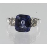 White gold (tests 18ct) diamond and sapphire trilogy ring, one cushion sapphire measures approx. 9mm