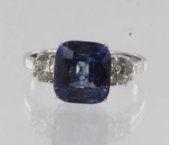 White gold (tests 18ct) diamond and sapphire trilogy ring, one cushion sapphire measures approx. 9mm