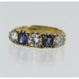 Yellow gold (tests 18ct) diamond and sapphire five stone ring, two oval sapphires measuring