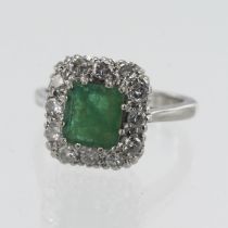 18ct White gold diamond and emerald cluster ring, one square step cut measures approx. 7.5mm x