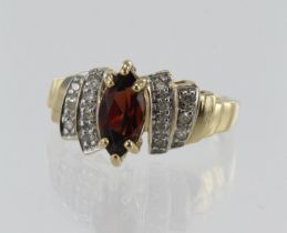 Yellow gold (tests 9ct) diamond and garnet dress ring, one marquise cut garnet measuring 10mm x 5mm,