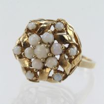 Yellow gold (tests 9ct) opal cluster ring, thirteen cabochon opals, principle measures 3.5mm, head