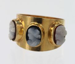 Yellow gold (tests 14ct) cameo trilogy ring, two carved shells and one carved onyx all depicting a